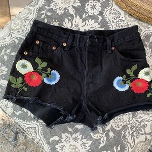 Levi’s black denim shorts with floral appliqués